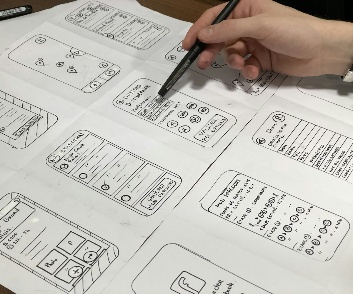 Designer sketching mobile app wireframes